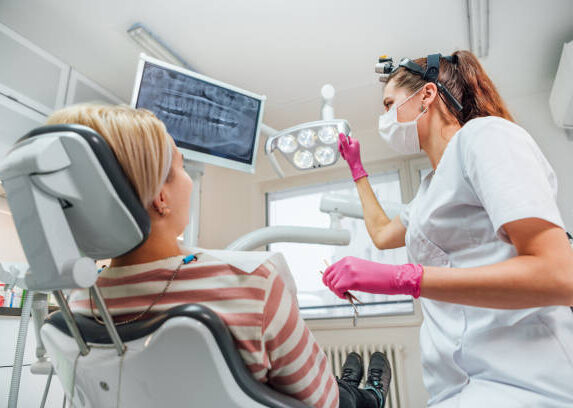 Dentist doctor examination Dental X-rays scan. Dental clinic patient visit modern medical ward. Female sitting in comfortable chair. Health care, medicare industry, heathcare technology concept image